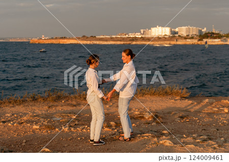 Women Holding Hands Beach Sunset Landscape 124009461