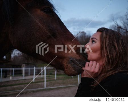 Young woman talking to her horse 124010081