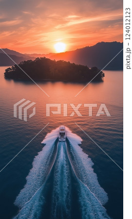 Breathtaking sunset over an island with a boat sailing in tranquil waters 124012123