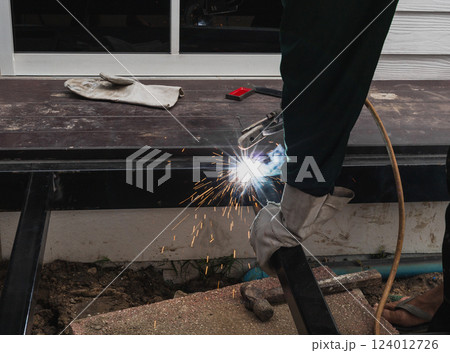Worker welder performs Arc welding process of metal structures. Worker welder performs Arc welding process of metal structures. 124012726