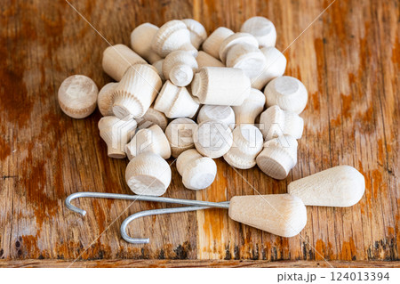 hooks and pile of russian biryulki wooden chips 124013394