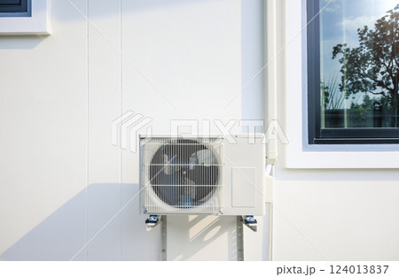 Condenser unit outside home. Condenser unit outside home. 124013837