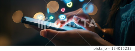 woman scrolling smartphone in neon lit city as hearts and social icons float symbolizing valentine day love copyspace concept of marketing, technology, commerce 124015232