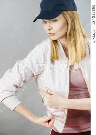 Young woman showing her arm muscles Young woman showing her arm muscles 124015869