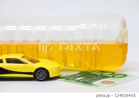A bottle of vegetable oil and a typewriter lie on a banknote. Biodiesel, biofuel, vegetable oil A bottle of vegetable oil and a typewriter lie on a banknote. Biodiesel, biofuel, vegetable oil 124016458