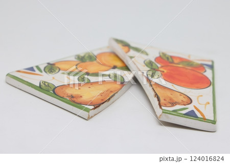 Cracked ceramic tile, broken into pieces, fragments of tiles. 124016824