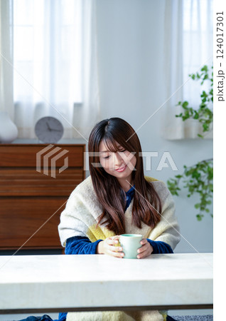 冬のリビングでくつろぐ若い女性 124017301