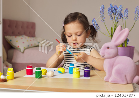Little child girl paint Easter eggs at home. kid is preparing for Easter. Little child girl paint Easter eggs at home. kid is preparing for Easter. 124017877