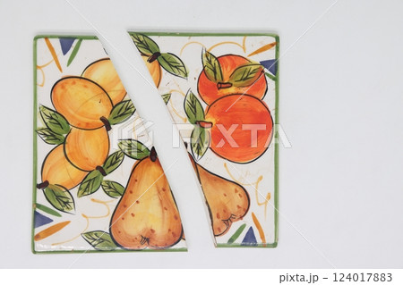 Cracked ceramic tile, broken into pieces, fragments of tiles. 124017883