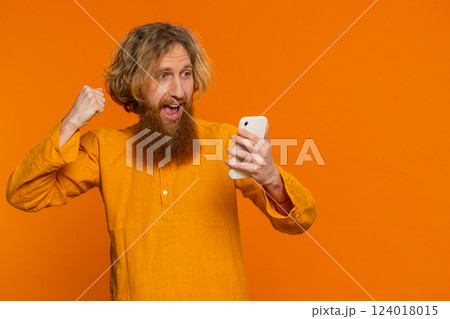 Happy excited winner man use smartphone celebrating success, winning play game, good lottery news 124018015