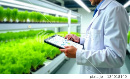 agronomist conducting digital inspection of indoor crops in automated greenhouse, advanced agricultural technologies, concept of sustainable agriculture and crop optimization 124018140