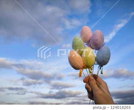 Multi colors Easter eggs on a bright sky background. Pastel color Easter eggs. Copy Space. Multi colors Easter eggs on a bright sky background. Pastel color Easter eggs. Copy Space. 124018203