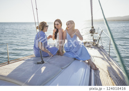 Three happy female friends enjoying summer travel Three happy female friends enjoying summer travel 124018416