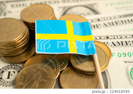 Stack of coins with Sweden flag and US dollar banknotes. 124018595