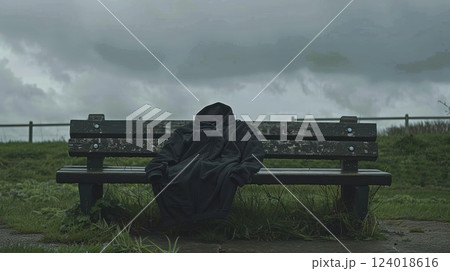 Empty Hoodie on Bench in Stormy Weather by Grass Field 124018616