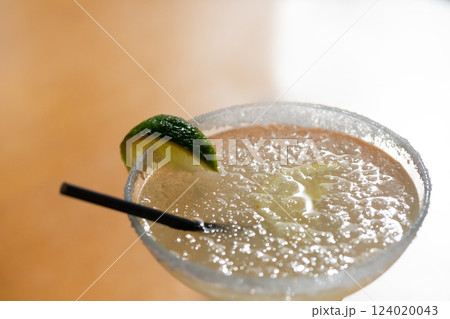 Margarita cocktail in a glass glass on a blurred background 124020043