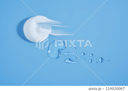 A smear of white cream And a drop of serum on a blue background. A smear of white cream And a drop of serum on a blue background. 124020067
