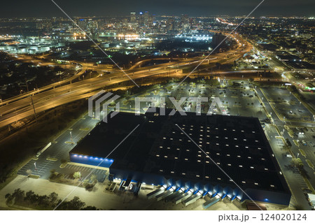 View from above of many parked cars on illuminaded parking lot with lines and markings for parking places and directions. Place for vehicles in front of a shopping mall center View from above of many parked cars on illuminaded parking lot with lines and markings for parking places and directions. Place for vehicles in front of a shopping mall center 124020124