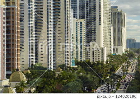 Sunny Isles Beach city with luxurious highrise hotels and condo buildings on Atlantic ocean shore. American tourism infrastructure in southern Florida 124020196