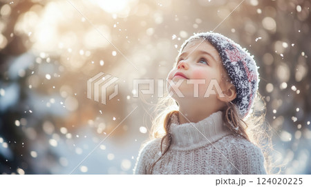 Joyful Child Watching Snowfall on a Winter Day 124020225