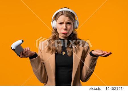 Sad disappointed gamer woman plays, lost online video game, console with gamepad 124021454