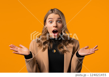 Surprised businesswoman, she expresses WOW, cant believe. Impressed lady trying to get attention. Concept of sales, profitable offer. Excited girl on yellow background 124021455