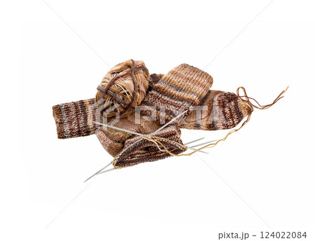 Knitted sock, ball of yarn and knitting needles on a white Knitted sock, ball of yarn and knitting needles on a white 124022084