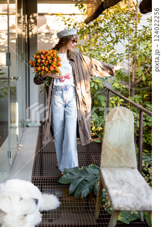 Stylish Woman with Tulips and White Dog 124022256