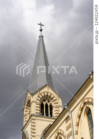 Majestic View of a Church Tower Under a Dramatic Cloudy Sky Majestic View of a Church Tower Under a Dramatic Cloudy Sky 124022459