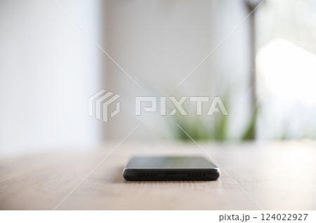 Minimalist smartphone on wooden surface Minimalist smartphone on wooden surface 124022927