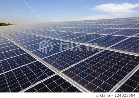 Office building with solar roof. Blue photovoltaic panels for producing clean ecological electric energy. Investing in renewable electricity concept 124023604