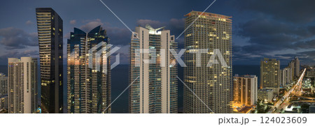 Night urban landscape of downtown district in Sunny Isles Beach city in Florida, USA. Skyline with brightly illuminated high skyscraper buildings in modern american megapolis Night urban landscape of downtown district in Sunny Isles Beach city in Florida, USA. Skyline with brightly illuminated high skyscraper buildings in modern american megapolis 124023609