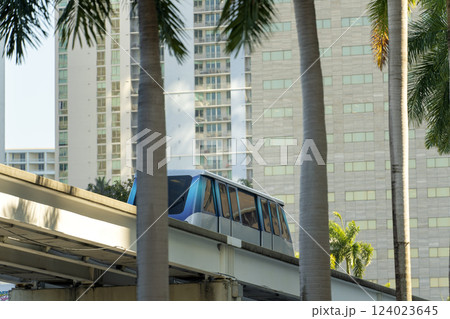 Metrorail city train car on high railroad over street traffic. Urban transportation in downtown district of Miami Brickell in Florida USA. 124023645