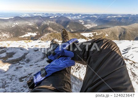 Mens legs in winter shoes against panorama over the Carpathian mountains. 124023647