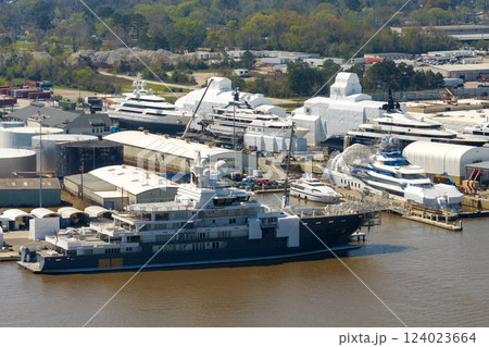 Large luxury yacht under construction in shipyard with cranes. Assembly of sea vessel Large luxury yacht under construction in shipyard with cranes. Assembly of sea vessel 124023664