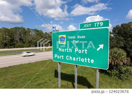 Interstate freeway exit sign in Florida, USA. I-75 highway interchange with direction to North Port and Port Charlotte Interstate freeway exit sign in Florida, USA. I-75 highway interchange with direction to North Port and Port Charlotte 124023678