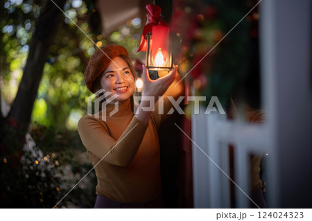 Outdoor Holiday Decorator Illumining Festive Lanterns at Evening Dusk Outdoor Holiday Decorator Illumining Festive Lanterns at Evening Dusk 124024323