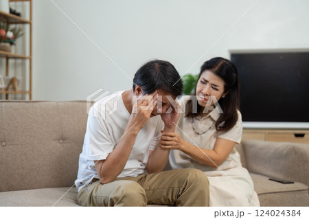 Elderly couple comforting each other during a moment of distress at home 124024384