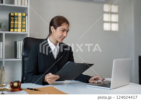 Lawyer working on case files at modern office desk professional environment focused viewpoint for legal insights 124024417