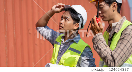 Logistics Planning. Young engineers assessing project details in a work environment. Logistics Planning. Young engineers assessing project details in a work environment. 124024557