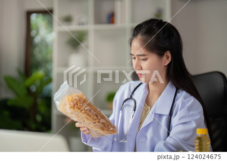 Nutritionist Check. Female nutritionist assessing food quality in a consultative setting. Nutritionist Check. Female nutritionist assessing food quality in a consultative setting. 124024675
