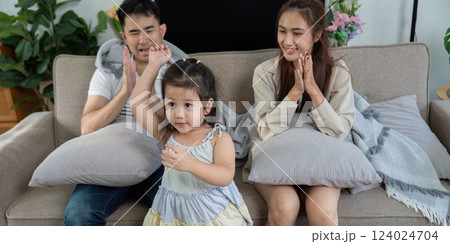 Joyful family engaging with their daughter during a fun moment at home Joyful family engaging with their daughter during a fun moment at home 124024704
