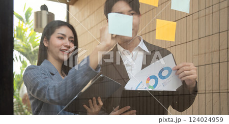 Individual writing on sticky notes for project planning and brainstorming. Individual writing on sticky notes for project planning and brainstorming. 124024959