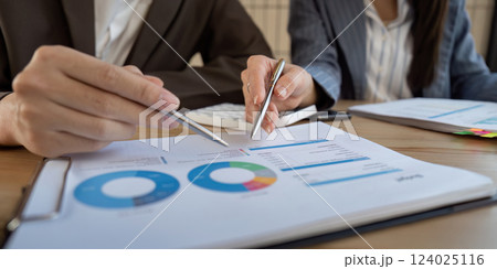Business collaboration. Professionals analyzing financial data together at a meeting table. Business collaboration. Professionals analyzing financial data together at a meeting table. 124025116