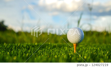 Golf ball on green grass in the evening golf course with sunshine background. Golf ball on green grass in the evening golf course with sunshine background. 124027219