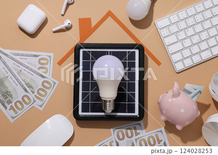 Portable solar panel with calculator and money Portable solar panel with calculator and money 124028253