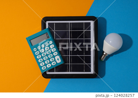 Portable solar panel with calculator and light bulb 124028257