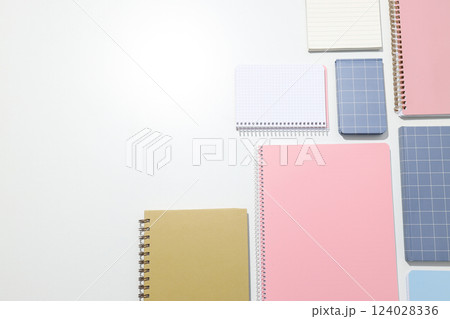 Different notebooks lie on a white background Different notebooks lie on a white background 124028336