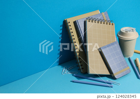 Notebooks with markers and coffee on a blue background 124028345