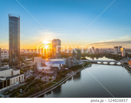 Yekaterinburg city and pond aerial panoramic view at summer or early autumn sunset. Night city in the early autumn or summer. Yekaterinburg city and pond aerial panoramic view at summer or early autumn sunset. Night city in the early autumn or summer. 124028857